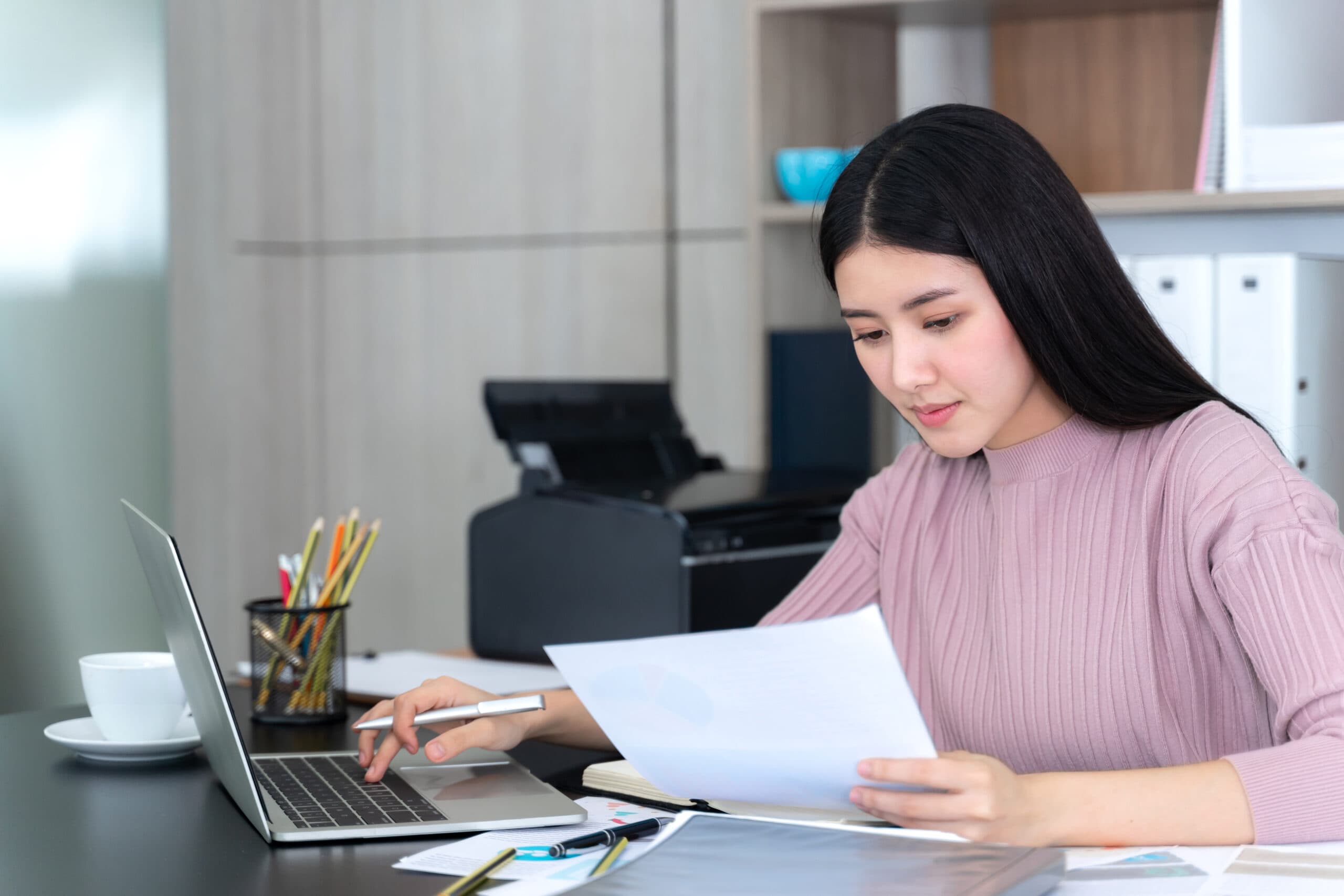 lifestyle-beautiful-asian-business-young-woman-using-laptop-computer-smart-phone-office-desk-scaled